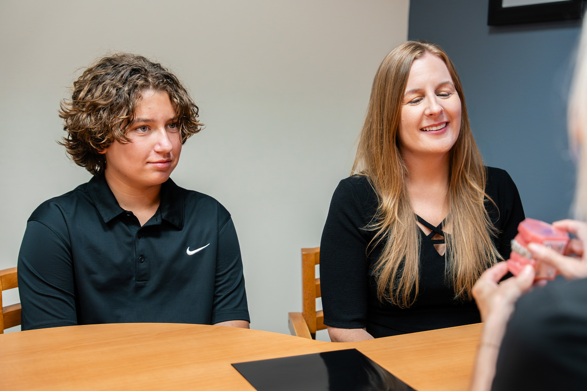 Maui Orthodontics patient and parent smiling during consultation.