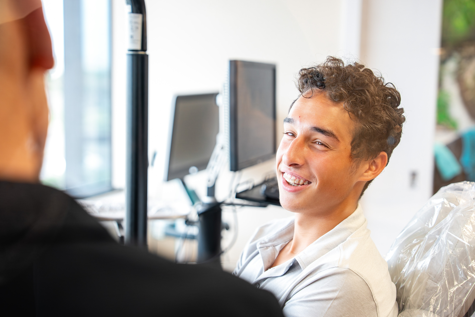 Smiling Maui Orthodontics patient during consultation with a friendly team member.