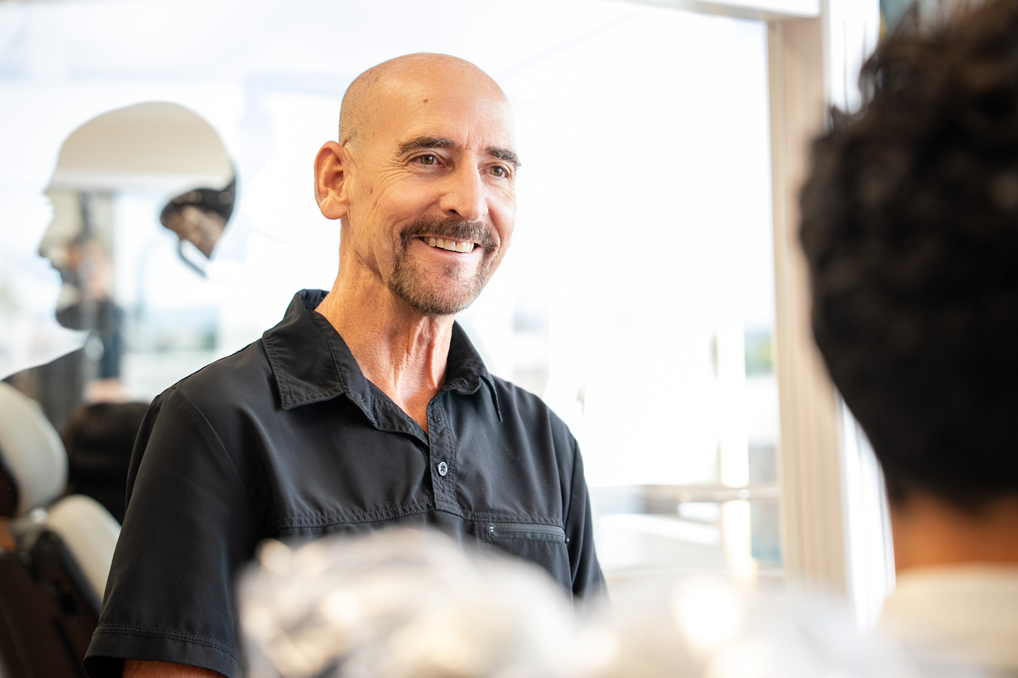 Dr. Paul Bonham, Maui orthodontist, smiling with patients in his Kahului practice