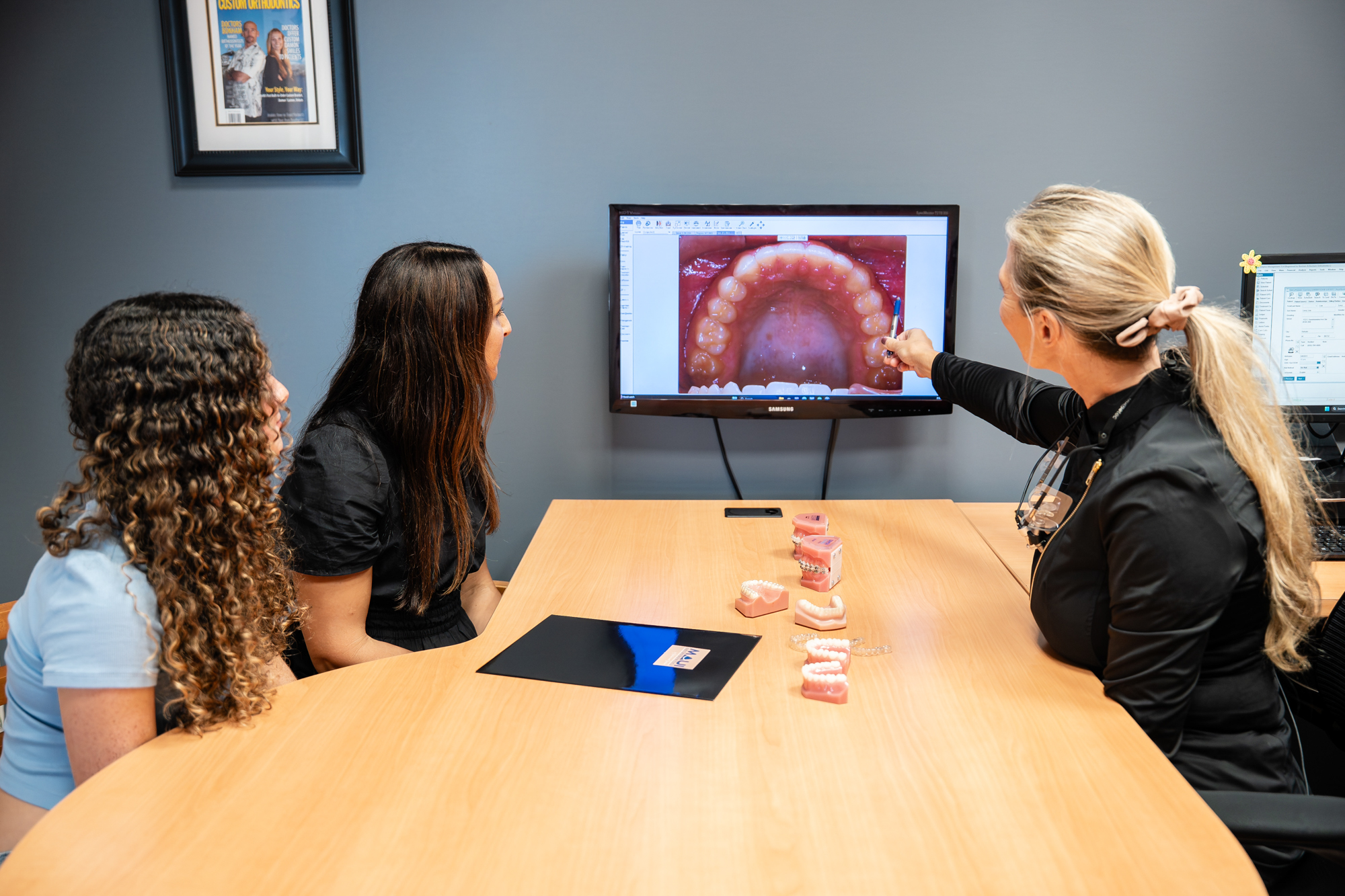 Maui Orthodontics consultation with patient and orthodontist reviewing dental model and treatment options.