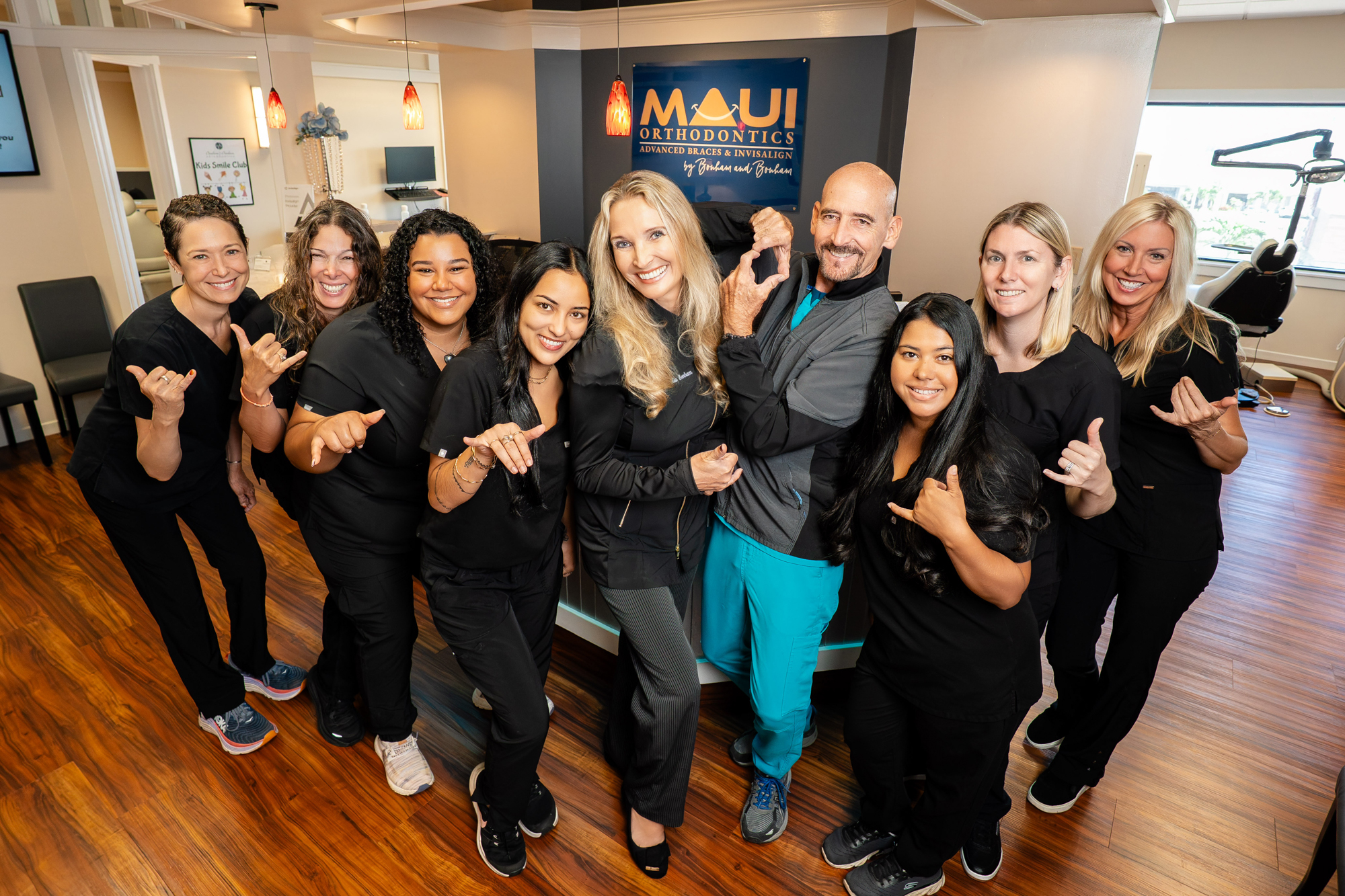 Maui Orthodontics team of professionals smiling and posing in office setting.