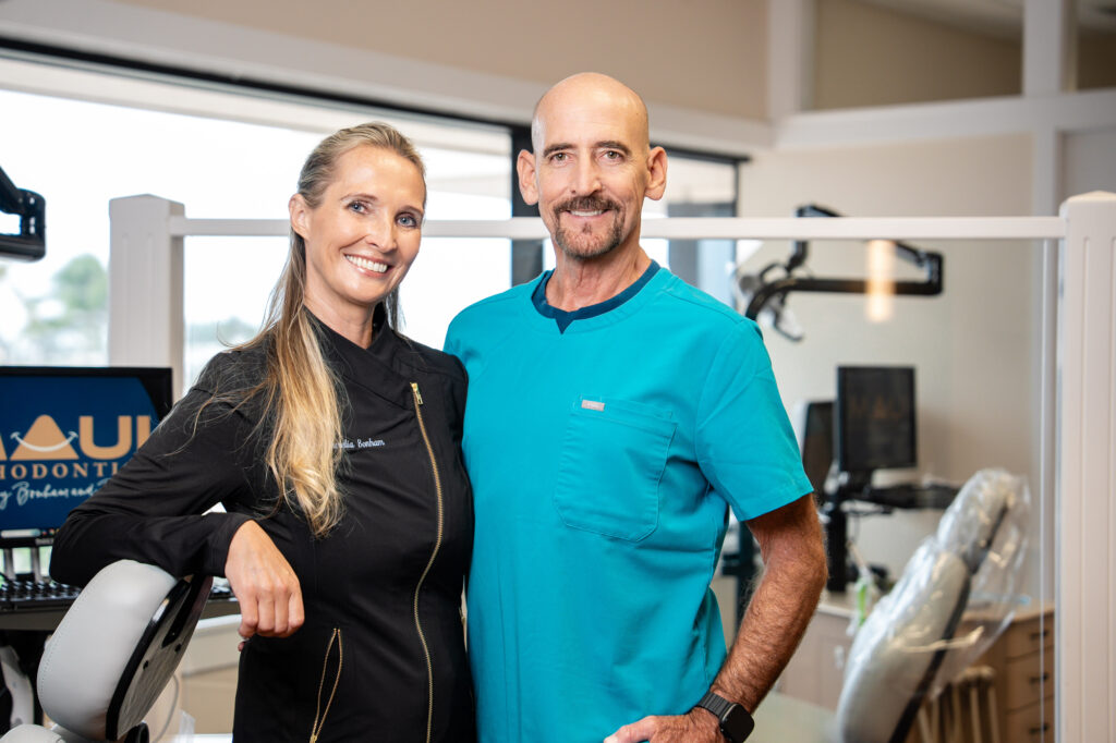 Dr. Aurelia Bonham and Dr. Paul Bonham, orthodontists at Maui Orthodontics, smiling together in their Kahului orthodontic office.
